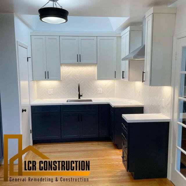 Remodeling a kitchen with white cabinets and black counter tops.
